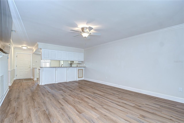 6550 Teak Ct, Zephyrhills, FL 33542 - unfurnished living room with a ceiling fan, light wood-style flooring, baseboards, and ornamental molding