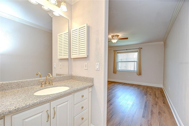 6550 Teak Ct, Zephyrhills, FL 33542 - bathroom featuring wood finished floors, crown molding, ceiling fan, vanity, and baseboards