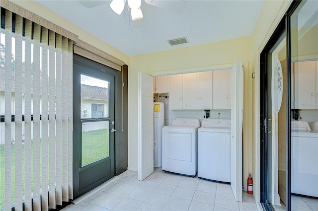 6550 Teak Ct, Zephyrhills, FL 33542 - laundry room with independent washer and dryer, cabinet space, light tile patterned floors, ceiling fan, and water heater