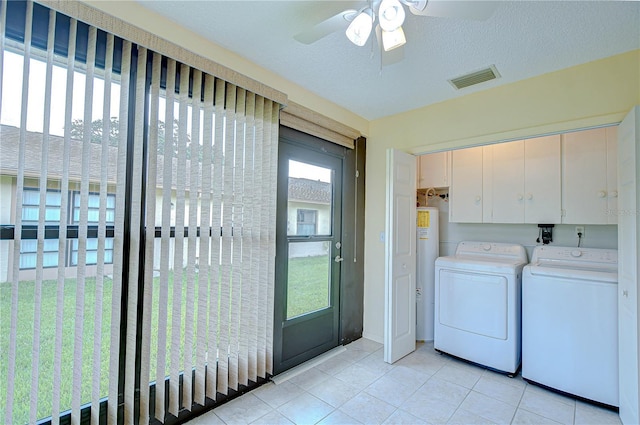 6550 Teak Ct, Zephyrhills, FL 33542 - laundry area featuring washer and dryer, electric water heater, cabinet space, light tile patterned flooring, and ceiling fan