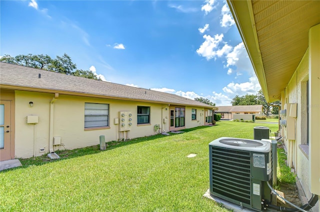 6550 Teak Ct, Zephyrhills, FL 33542 - view of green lawn featuring central AC