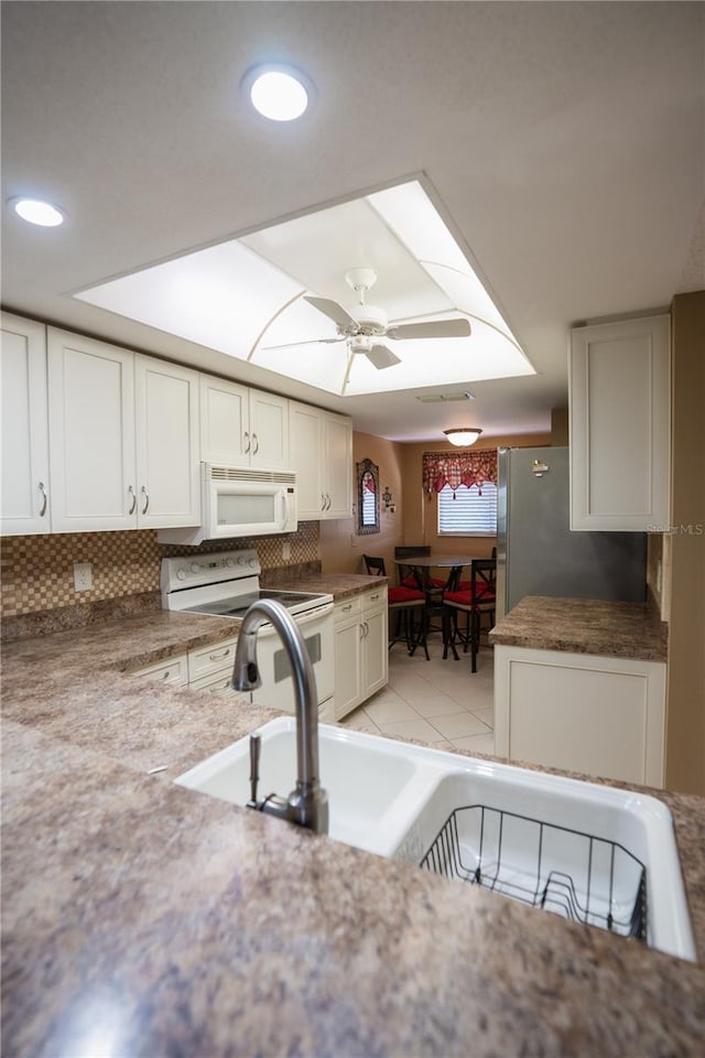 1846 Golfview Dr Unit 1846, Tarpon Springs, FL 34689 - kitchen featuring white appliances, decorative backsplash, white cabinets, a ceiling fan, and recessed lighting