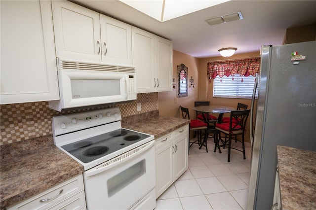 1846 Golfview Dr Unit 1846, Tarpon Springs, FL 34689 - kitchen featuring white appliances, white cabinetry, and backsplash