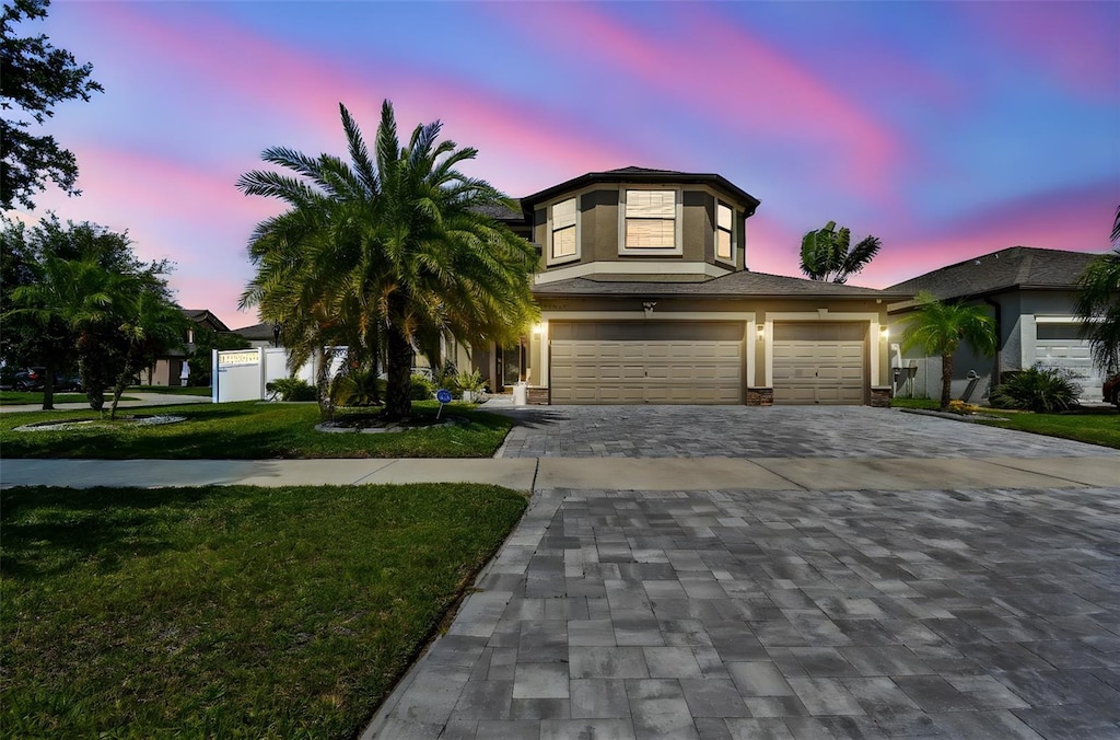 11602 Sunburst Marble Rd, Riverview, FL 33579 - view of front of property featuring decorative driveway, stucco siding, and a garage