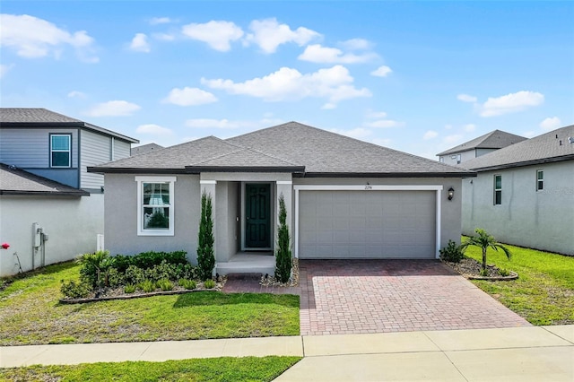 2296 Crossbow St, Clermont, FL 34715 - view of front of property with an attached garage, decorative driveway, roof with shingles, and a front lawn