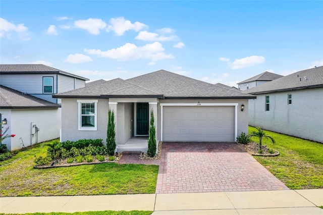 2296 Crossbow St, Clermont, FL 34715 - view of front of home with an attached garage, decorative driveway, roof with shingles, stucco siding, and a front lawn