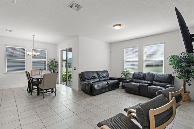 2296 Crossbow St, Clermont, FL 34715 - living area featuring a chandelier, plenty of natural light, and light tile patterned floors
