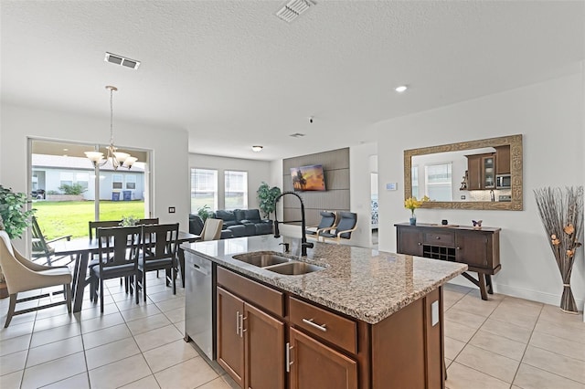 2296 Crossbow St, Clermont, FL 34715 - kitchen featuring a sink, appliances with stainless steel finishes, a chandelier, light tile patterned floors, and light stone counters