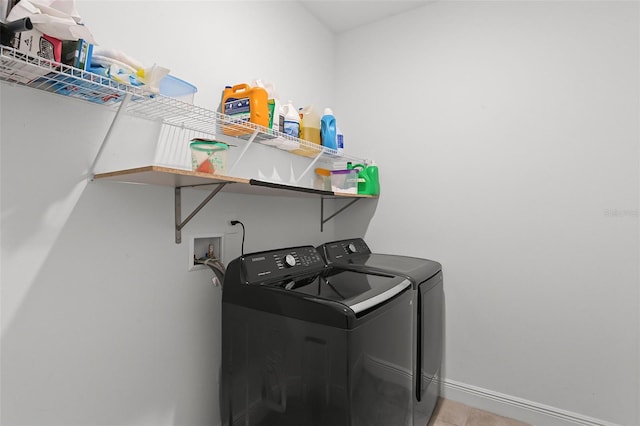 2296 Crossbow St, Clermont, FL 34715 - laundry room featuring washing machine and dryer, baseboards, and light tile patterned floors