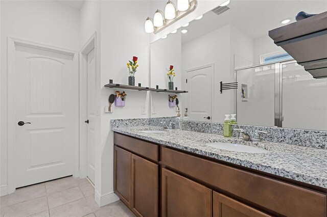 2296 Crossbow St, Clermont, FL 34715 - full bath with double vanity, tile patterned floors, a shower stall, recessed lighting, and baseboards