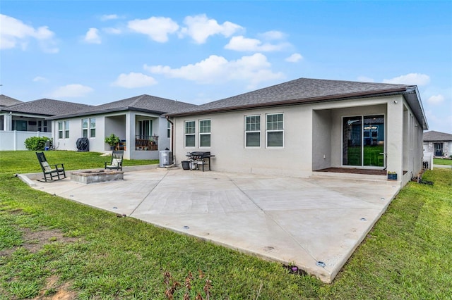 2296 Crossbow St, Clermont, FL 34715 - back of property featuring stucco siding, an outdoor fire pit, a patio area, a yard, and roof with shingles