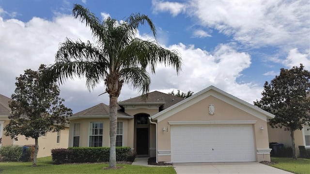 189 Minniehaha Cir, Haines City, FL 33844 - view of front of home with stucco siding, concrete driveway, an attached garage, and a front lawn