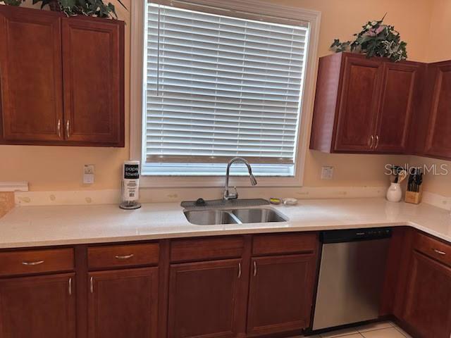 189 Minniehaha Cir, Haines City, FL 33844 - kitchen featuring stainless steel dishwasher, a sink, light countertops, and healthy amount of natural light