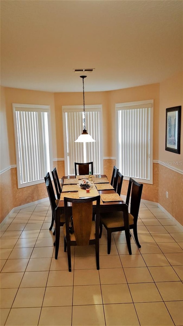 189 Minniehaha Cir, Haines City, FL 33844 - dining area with light tile patterned flooring and a wainscoted wall