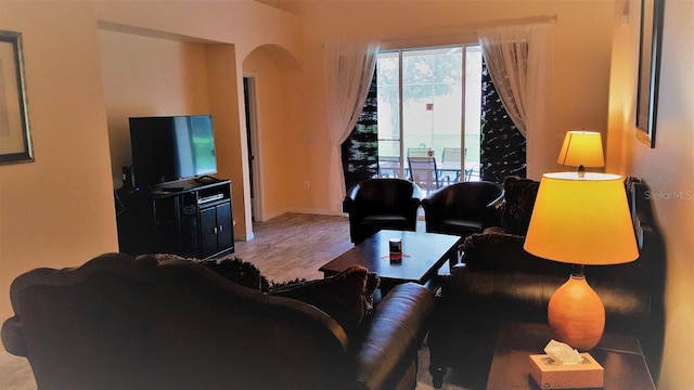 189 Minniehaha Cir, Haines City, FL 33844 - living area with arched walkways, wood finished floors, and baseboards