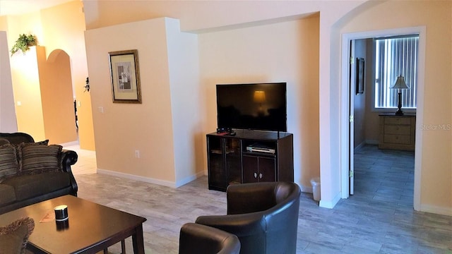 189 Minniehaha Cir, Haines City, FL 33844 - living room with arched walkways, baseboards, and light wood-style flooring