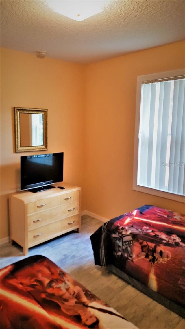 189 Minniehaha Cir, Haines City, FL 33844 - carpeted bedroom featuring baseboards and a textured ceiling