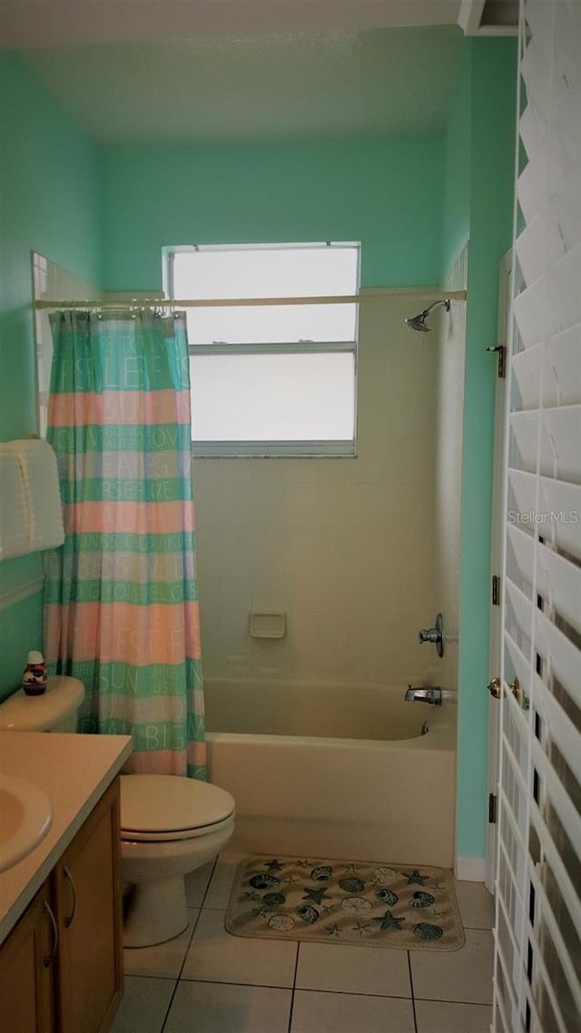 189 Minniehaha Cir, Haines City, FL 33844 - bathroom featuring vanity, shower / bathtub combination with curtain, toilet, and tile patterned flooring