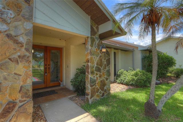 313 Oak Crest Dr, Safety Harbor, FL 34695 - doorway to property with stone siding, french doors, and stucco siding