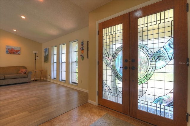 313 Oak Crest Dr, Safety Harbor, FL 34695 - tiled entryway featuring french doors, vaulted ceiling, baseboards, recessed lighting, and a textured ceiling