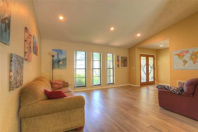 313 Oak Crest Dr, Safety Harbor, FL 34695 - living area with lofted ceiling, recessed lighting, plenty of natural light, light wood-style floors, and baseboards