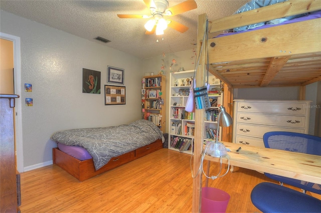 313 Oak Crest Dr, Safety Harbor, FL 34695 - bedroom featuring wood finished floors, baseboards, a textured ceiling, and ceiling fan