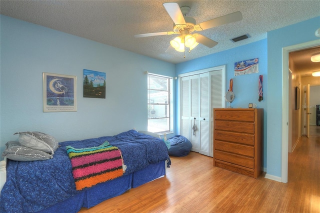 313 Oak Crest Dr, Safety Harbor, FL 34695 - bedroom with wood finished floors, a textured ceiling, a closet, and ceiling fan