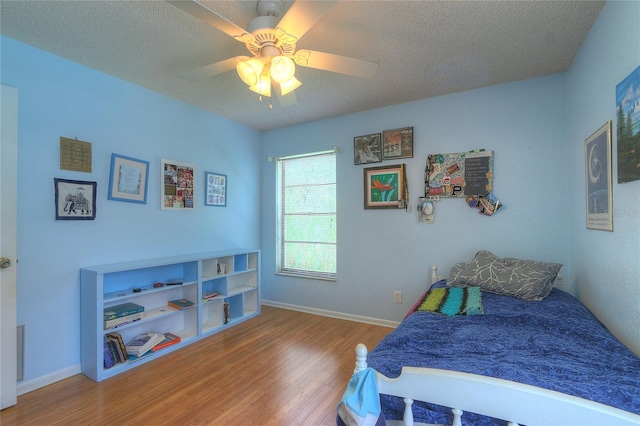 313 Oak Crest Dr, Safety Harbor, FL 34695 - bedroom featuring wood finished floors, a ceiling fan, baseboards, and a textured ceiling