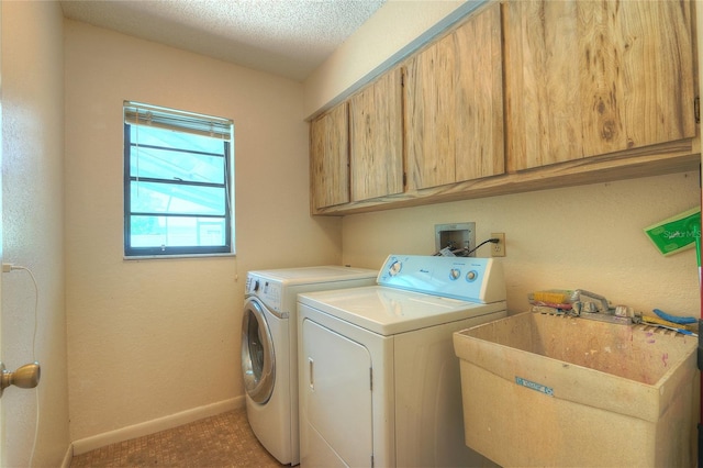 313 Oak Crest Dr, Safety Harbor, FL 34695 - laundry room featuring cabinet space, washer and clothes dryer, baseboards, light colored carpet, and a textured ceiling