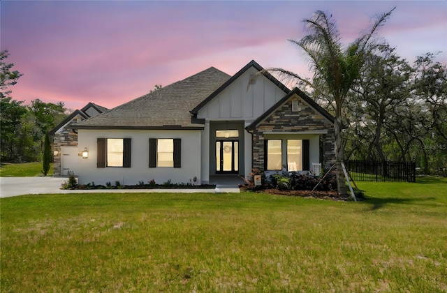 13334 Oldenburg Dr, Hudson, FL 34667 - view of front of house featuring stone siding, board and batten siding, a shingled roof, and a garage