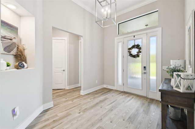 13334 Oldenburg Dr, Hudson, FL 34667 - foyer entrance featuring a chandelier, wood finished floors, ornamental molding, baseboards, and a towering ceiling