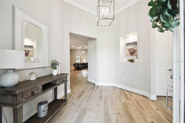 13334 Oldenburg Dr, Hudson, FL 34667 - foyer featuring crown molding, wood finished floors, baseboards, and a chandelier