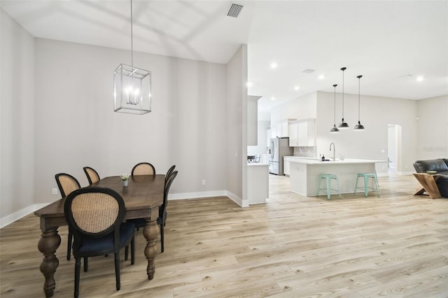 13334 Oldenburg Dr, Hudson, FL 34667 - dining space featuring baseboards, light wood-type flooring, a chandelier, and recessed lighting