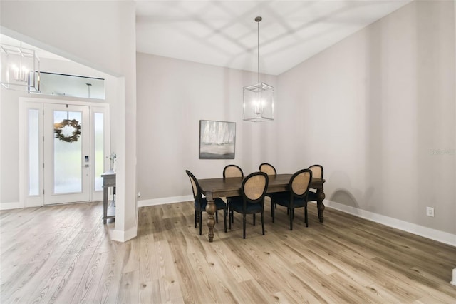 13334 Oldenburg Dr, Hudson, FL 34667 - dining area with a chandelier, light wood-type flooring, and baseboards