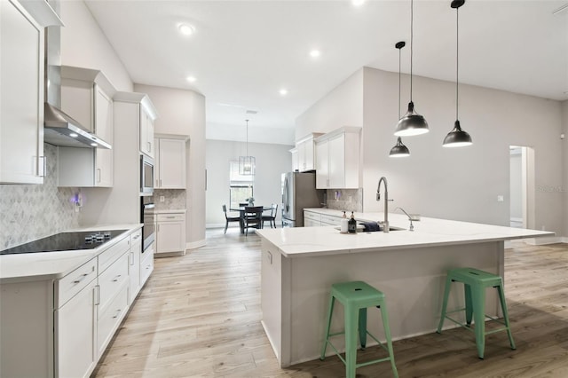 13334 Oldenburg Dr, Hudson, FL 34667 - kitchen with a sink, light wood-style flooring, appliances with stainless steel finishes, tasteful backsplash, and recessed lighting