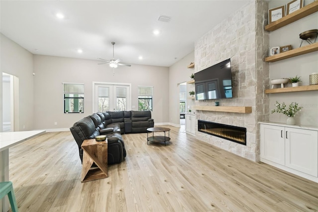13334 Oldenburg Dr, Hudson, FL 34667 - living room featuring ceiling fan, a stone fireplace, light wood-type flooring, recessed lighting, and baseboards