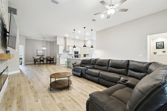 13334 Oldenburg Dr, Hudson, FL 34667 - living room with ceiling fan, light wood finished floors, recessed lighting, baseboards, and a chandelier