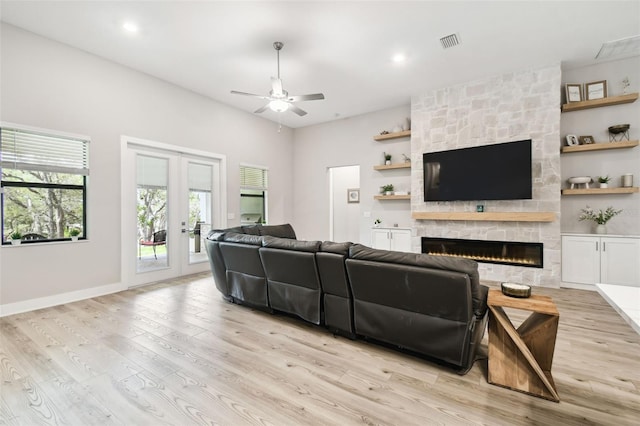 13334 Oldenburg Dr, Hudson, FL 34667 - living room featuring a ceiling fan, plenty of natural light, a stone fireplace, light wood-style floors, and recessed lighting