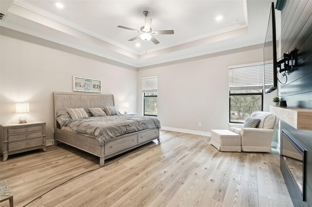 13334 Oldenburg Dr, Hudson, FL 34667 - bedroom featuring a tray ceiling, ornamental molding, light wood-type flooring, recessed lighting, and baseboards