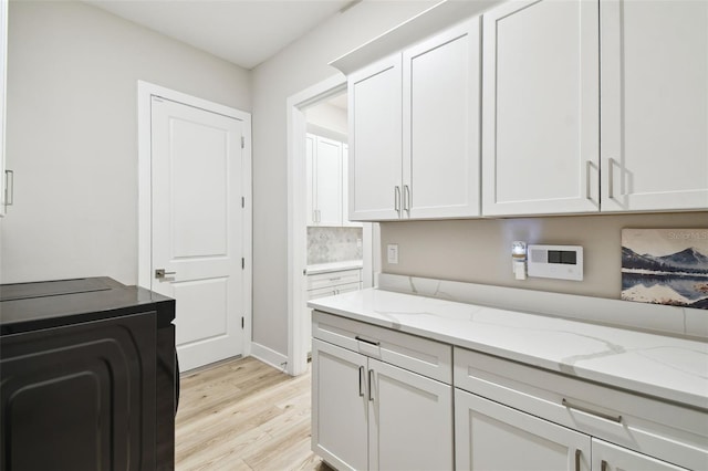 13334 Oldenburg Dr, Hudson, FL 34667 - washroom with cabinet space and light wood-style flooring