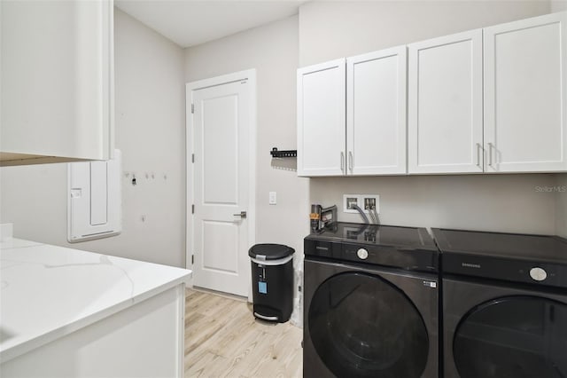13334 Oldenburg Dr, Hudson, FL 34667 - laundry room with cabinet space, washer and clothes dryer, and light wood-style floors