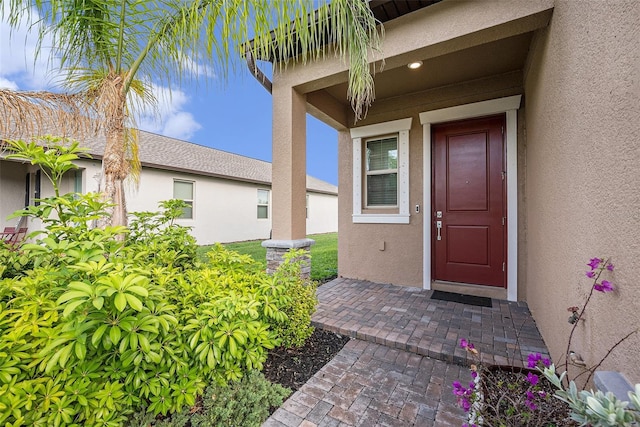 8719 Winning Fields Rd, New Port Richey, FL 34655 - doorway to property featuring stucco siding