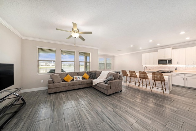 8719 Winning Fields Rd, New Port Richey, FL 34655 - living room featuring ornamental molding, ceiling fan, baseboards, recessed lighting, and a textured ceiling