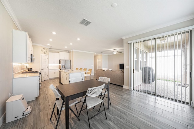 8719 Winning Fields Rd, New Port Richey, FL 34655 - dining space featuring crown molding, recessed lighting, ceiling fan, and baseboards