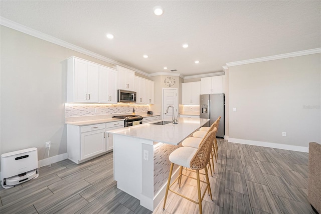 8719 Winning Fields Rd, New Port Richey, FL 34655 - kitchen featuring stainless steel appliances, a sink, a kitchen bar, recessed lighting, and wood tiled floors