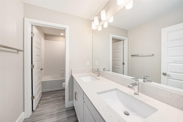 8719 Winning Fields Rd, New Port Richey, FL 34655 - full bath featuring double vanity, toilet, baseboards, wood finished floors, and washtub / shower combination