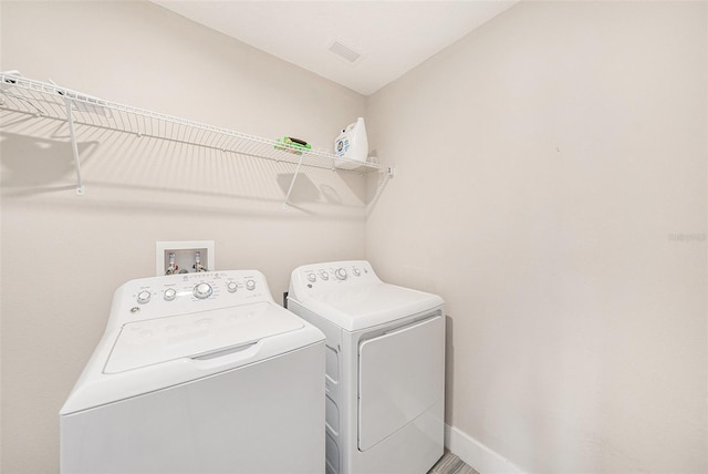 8719 Winning Fields Rd, New Port Richey, FL 34655 - laundry room featuring washer and dryer and baseboards