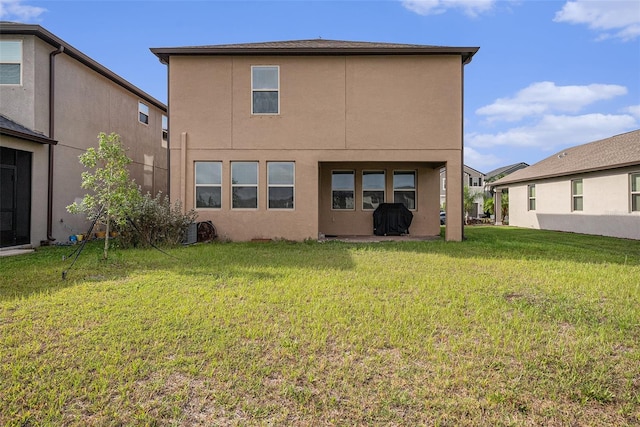 8719 Winning Fields Rd, New Port Richey, FL 34655 - back of house with stucco siding and a yard