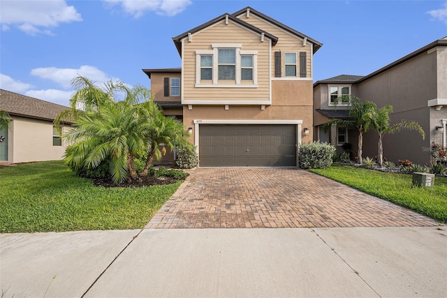 8719 Winning Fields Rd, New Port Richey, FL 34655 - traditional-style home featuring decorative driveway, a garage, a front yard, and stucco siding