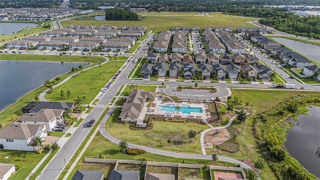 8719 Winning Fields Rd, New Port Richey, FL 34655 - aerial view of property's location with a large body of water, a pool area, and nearby suburban area